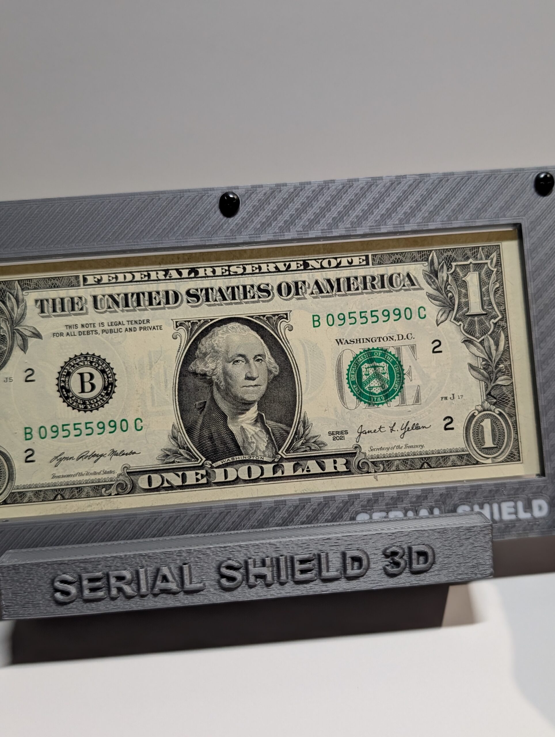 Gray carbon fiber Serial Shield 3D currency frame with stand and 7 mil Mylar window