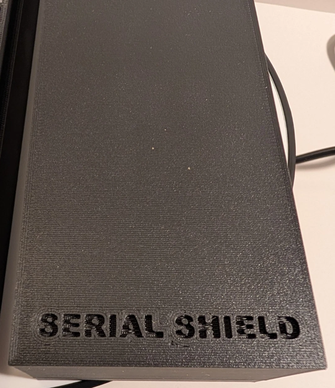 Serial Shield 3D embossed logo on black 20-slot coin holder storage box